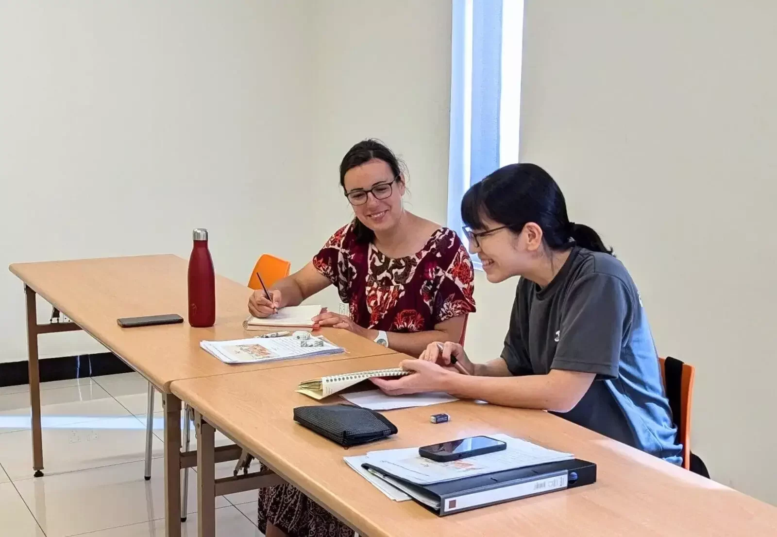 Two G2K students practice speaking Khmer together